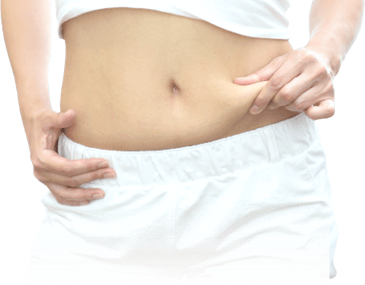 おなかをつまむ女性